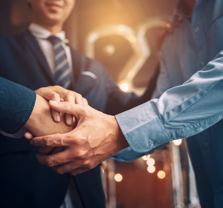 Business shaking hands, finishing up meeting. Successful businessmen handshaking after good deal.