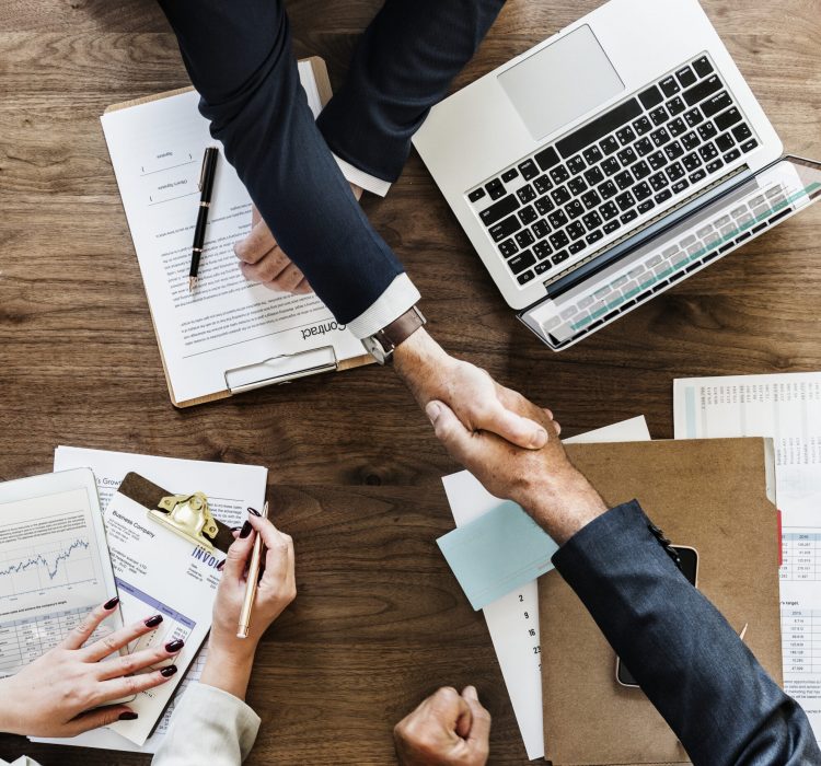 Business people shaking hands together